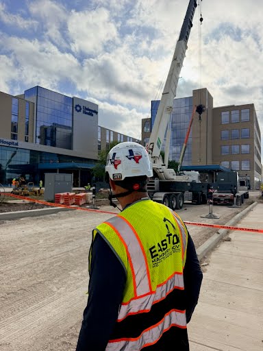Easton crew member directing a crane lift outside University Health Hospital San Antonio